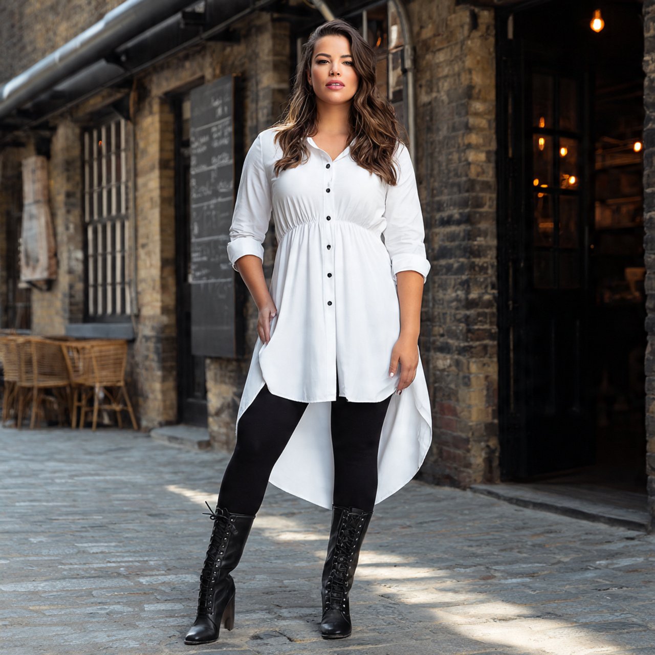 longline white shirt with black leggings and boots
