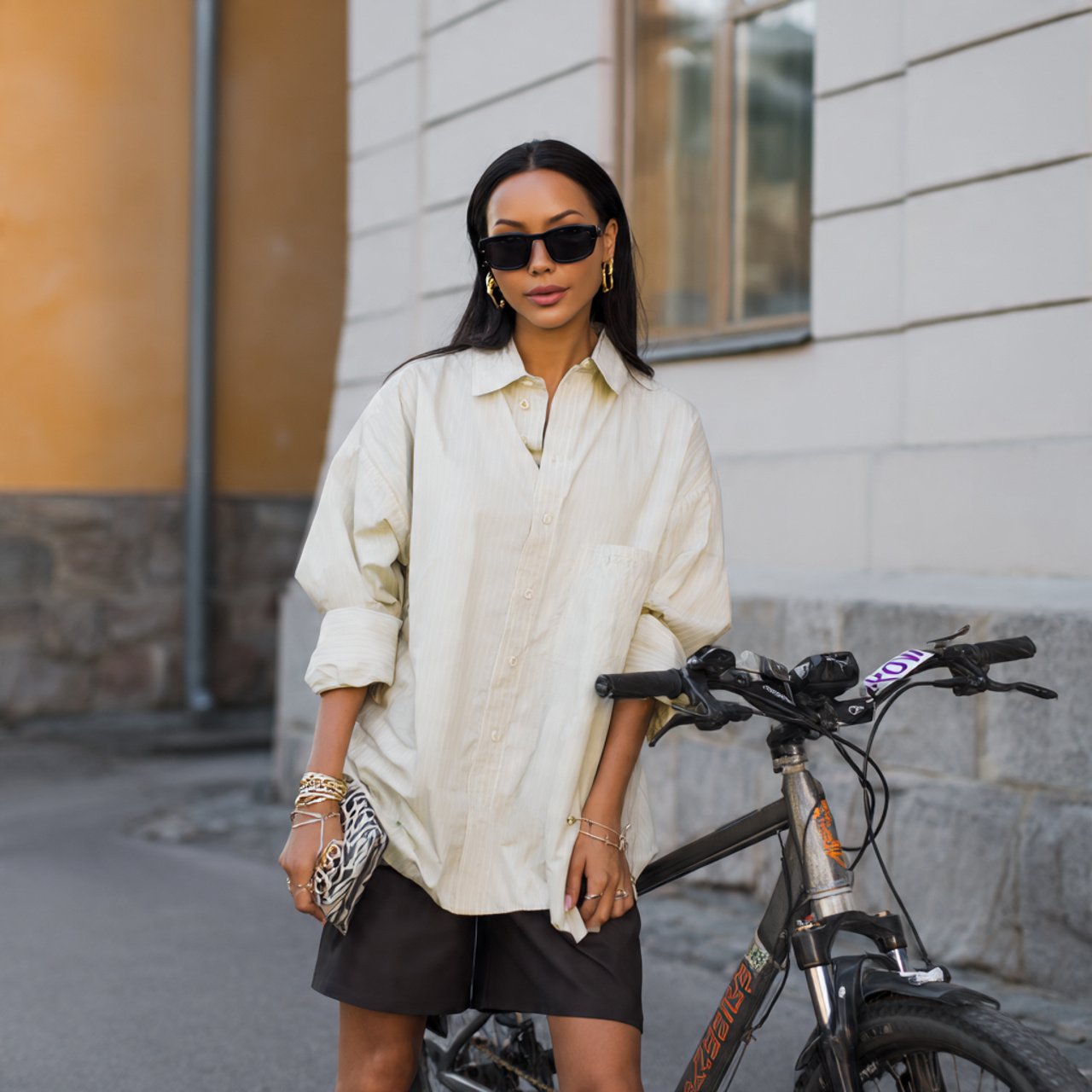 oversized shirt with bike shorts and sleek accesso